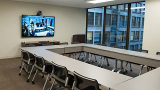 Conference Room D boardroom style with video conferencing 